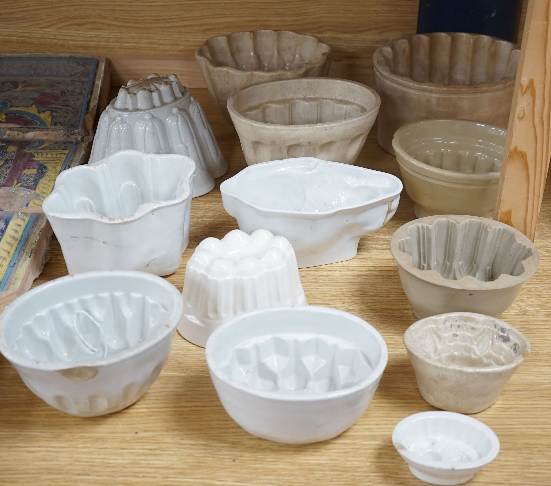 A collection of thirteen various sized 19th and 20th century ceramic jelly moulds